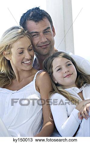 Parents and daughter smiling for the camera, outdoors View Large Photo Image Stock Image - Parents and daughter smiling for the camera, outdoors. Fotosearch
