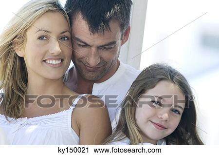 Parents and daughter smiling for the camera, outdoors View Large Photo Image Stock Image - Parents and daughter smiling for the camera, outdoors. Fotosearch