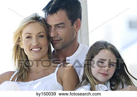 Parents and daughter smiling for the camera, outdoors View Large Photo Image Stock Photo - Parents and daughter smiling for the camera, outdoors. Fotosearch