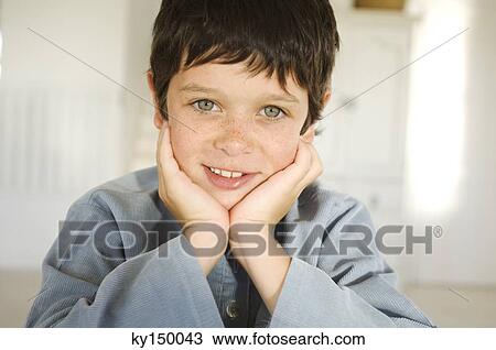 Portrait of little boy with hands on chin View Large Photo Image Stock Image - Portrait of little boy with hands on chin. Fotosearch