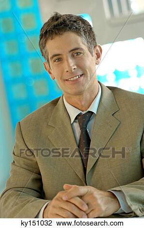 Businessman sitting in office, portrait View Large Photo Image Stock Image - Businessman sitting in office, portrait. Fotosearch