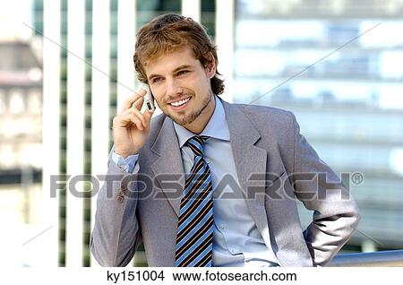 Businessman using mobile phone, smiling View Large Photo Image Picture - Businessman using mobile phone, smiling. Fotosearch