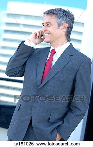 Businessman using mobile phone, smiling View Large Photo Image Stock Photograph - Businessman using mobile phone, smiling. Fotosearch
