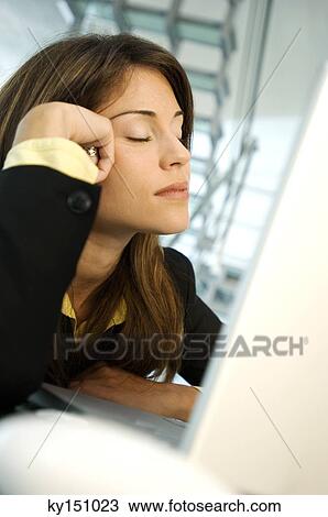 Businesswoman sitting with eyes closed, side view View Large Photo Image Stock Image - Businesswoman sitting with eyes closed, side view. Fotosearch