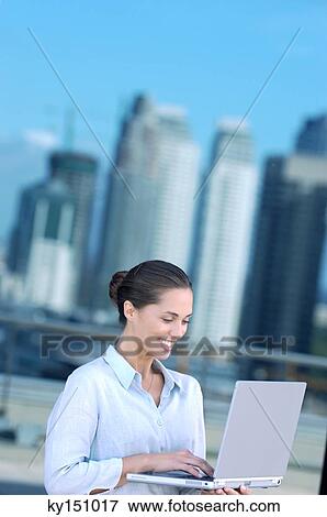 Businesswoman using laptop, smiling View Large Photo Image Stock Photo - Businesswoman using laptop, smiling. Fotosearch