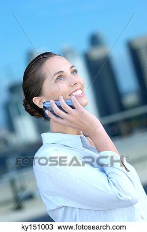 Businesswoman using mobile phone, side view View Large Photo Image Stock Image - Businesswoman using mobile phone, side view. Fotosearch