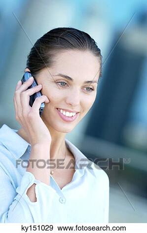 Businesswoman using mobile phone, smiling View Large Photo Image Stock Photo - Businesswoman using mobile phone, smiling. Fotosearch
