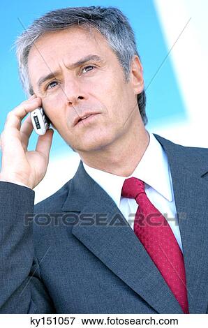 Mature businessman using mobile phone, close-up View Large Photo Image Stock Photo - Mature businessman using mobile phone, close-up. Fotosearch
