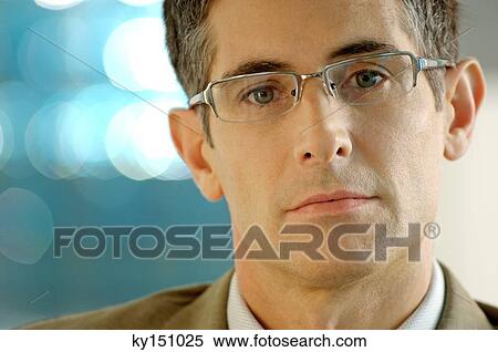 Mid adult man wearing glasses, close-up View Large Photo Image Stock Photography - Mid adult man wearing glasses, close-up. Fotosearch