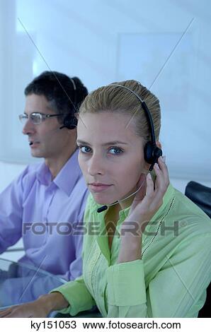 Young businessman and businesswoman wearing headset, portrait View Large Photo Image Stock Image - Young businessman and businesswoman wearing headset, portrait. Fotosearch
