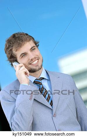 Young businessman using mobile phone View Large Photo Image Stock Photo - Young businessman using mobile phone. Fotosearch