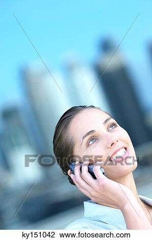 Stock Image - Young businesswoman using mobile phone. Fotosearch