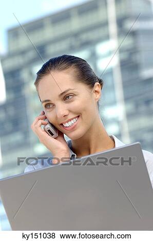 Young businesswoman using mobile phone View Large Photo Image Stock Photo - Young businesswoman using mobile phone. Fotosearch