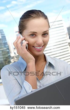 Stock Photography - Young businesswoman using mobile phone, portrait. Fotosearch
