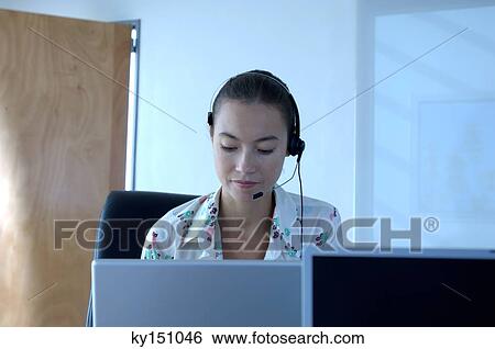 Young businesswoman wearing headset View Large Photo Image Stock Photograph - Young businesswoman wearing headset. Fotosearch