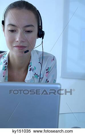 Young businesswoman wearing headset, close-up View Large Photo Image Stock Photography - Young businesswoman wearing headset, close-up. Fotosearch