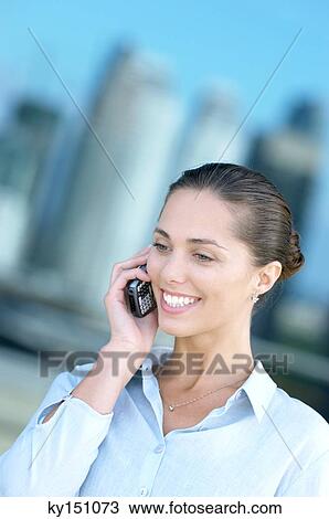 Young woman using mobile phone View Large Photo Image Stock Image - Young woman using mobile phone. Fotosearch