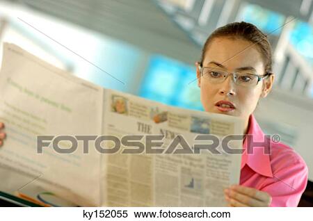Businesswoman reading newspaper View Large Photo Image Stock Photography - Businesswoman reading newspaper. Fotosearch