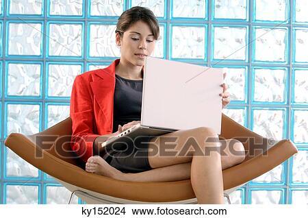 Picture - Businesswoman using laptop on chair. Fotosearch