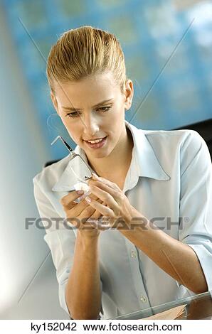 Young businesswoman cleaning glasses View Large Photo Image Stock Image - Young businesswoman cleaning glasses. Fotosearch