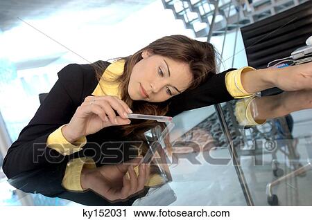 Young businesswoman leaning on glass tabletop View Large Photo Image Stock Image - Young businesswoman leaning on glass tabletop. Fotosearch