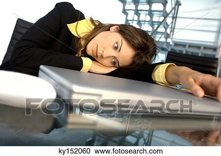 Young businesswoman leaning on glass table by laptop View Large Photo Image Stock Image - Young businesswoman leaning on glass table by laptop. Fotosearch