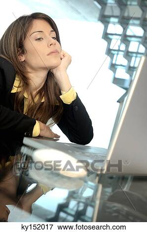 Young businesswoman looking at laptop View Large Photo Image Stock Photo - Young businesswoman looking at laptop. Fotosearch