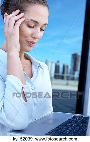 Young businesswoman looking at laptop View Large Photo Image Stock Photo - Young businesswoman looking at laptop. Fotosearch
