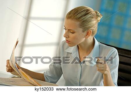 Young businesswoman reading newspaper View Large Photo Image Stock Image - Young businesswoman reading newspaper. Fotosearch
