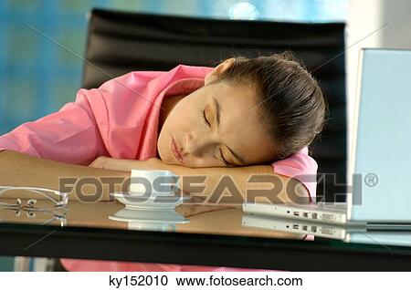 Young businesswoman relaxing on glass desk View Large Photo Image Stock Image - Young businesswoman relaxing on glass desk. Fotosearch