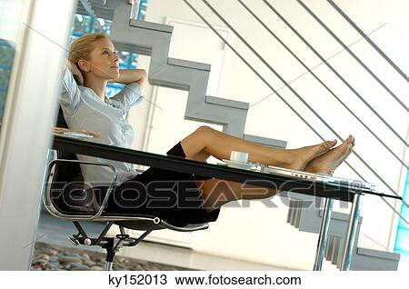 Young businesswoman relaxing on office chair View Large Photo Image Stock Image - Young businesswoman relaxing on office chair. Fotosearch