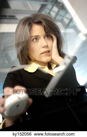 Stock Photograph - Young businesswoman working on laptop. Fotosearch