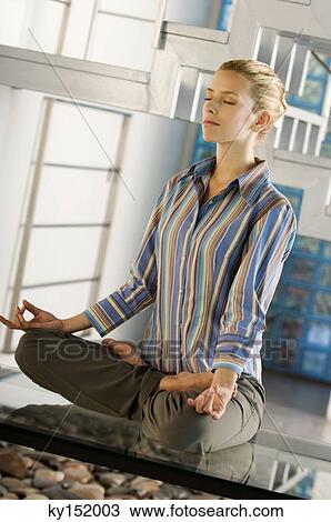 Young woman practicing yoga View Large Photo Image Stock Image - Young woman practicing yoga. Fotosearch
