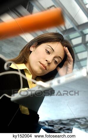 Young woman using laptop, low angle view View Large Photo Image Picture - Young woman using laptop, low angle view. Fotosearch
