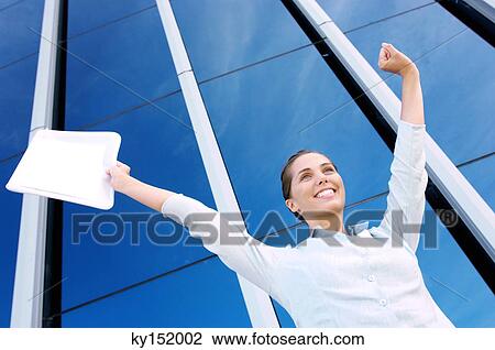 Young woman with arm raised, low angle view View Large Photo Image Stock Image - Young woman with arm raised, low angle view. Fotosearch