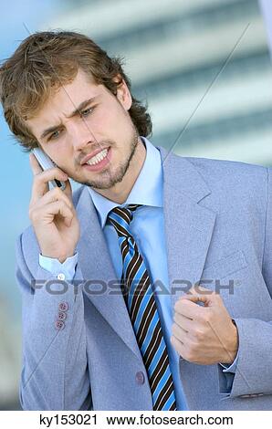 Businessman conversing on mobile phone, close-up View Large Photo Image Stock Image - Businessman conversing on mobile phone, close-up. Fotosearch