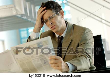 Stock Photo - Businessman reading newspaper. Fotosearch