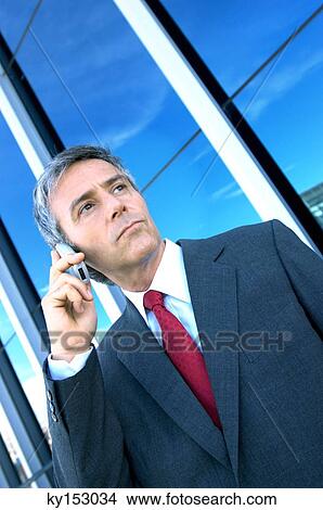 Mature businessman using mobile phone View Large Photo Image Picture - Mature businessman using mobile phone. Fotosearch