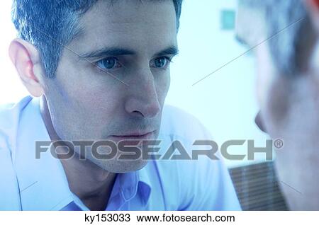Mid adult businessman looking in mirror at washroom, close-up View Large Photo Image Stock Image - Mid adult businessman looking in mirror at washroom, close-up. Fotosearch