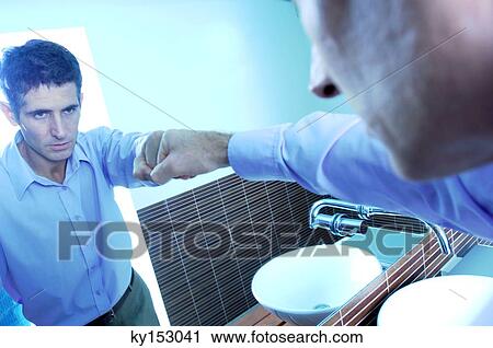 Mid adult businessman looking in mirror, close-up View Large Photo Image Stock Image - Mid adult businessman looking in mirror, close-up. Fotosearch