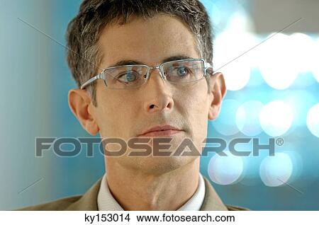 Mid adult businessman wearing glasses, close-up View Large Photo Image Picture - Mid adult businessman wearing glasses, close-up. Fotosearch