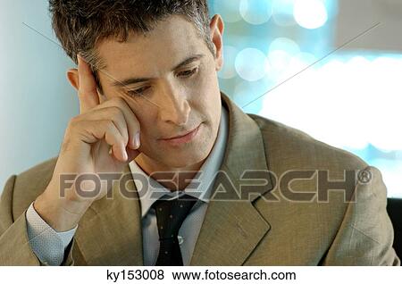 Mid adult businessman with hand on forehead View Large Photo Image Stock Photo - Mid adult businessman with hand on forehead. Fotosearch