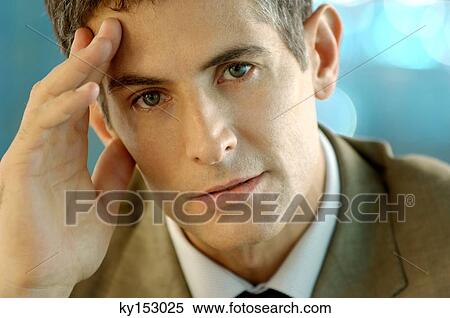 Mid adult businessman with head in hands, portrait View Large Photo Image Stock Photography - Mid adult businessman with head in hands, portrait. Fotosearch
