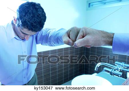 Reflection of mid adult man in mirror at washroom View Large Photo Image Stock Photo - Reflection of mid adult man in mirror at washroom. Fotosearch