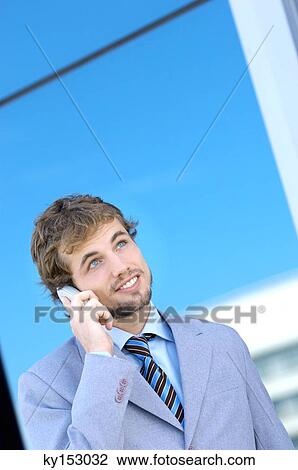 Young businessman using mobile phone, smiling View Large Photo Image Stock Image - Young businessman using mobile phone, smiling. Fotosearch