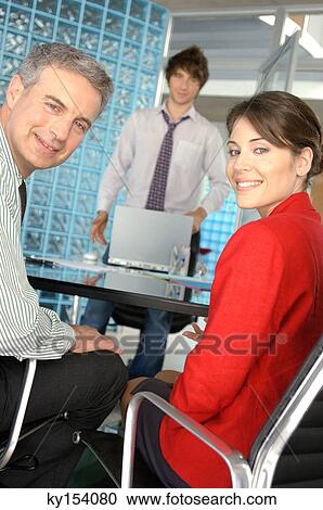 Business people at office, smiling, portrait View Large Photo Image Stock Image - Business people at office, smiling, portrait. Fotosearch