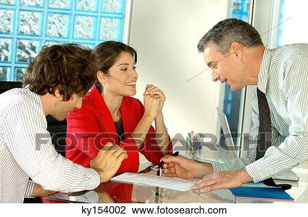 Business people conversing in office, smiling View Large Photo Image Stock Image - Business people conversing in office, smiling. Fotosearch
