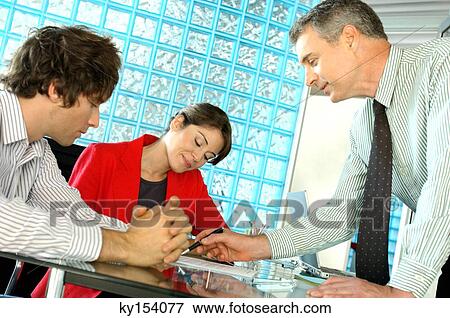 Business people discussing at office View Large Photo Image Stock Photo - Business people discussing at office. Fotosearch