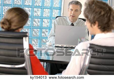 Business people discussing in office View Large Photo Image Stock Image - Business people discussing in office. Fotosearch