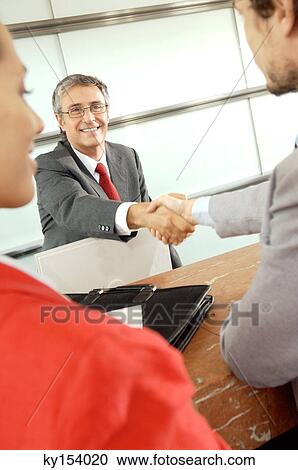 Business people shaking hands in office, smiling View Large Photo Image Stock Image - Business people shaking hands in office, smiling. Fotosearch